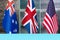 Collage of flags of Australia, the United Kingdom and United States.