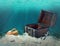 collage of opened empty old wooden treasure chest submerged underwater world with anchor, amphora and light rays, close up, copy