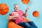 Collage picture of impressed funny pensioner sit orange bag eat popcorn isolated on blue color background