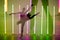 Collage of shadows of a ballet dancer young woman dancing and posing in a dark studio with bright neon lights