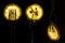 Collage of three slices of lemons on the fork on dark black background. silhouette of a fork in the back light. Drops of juice