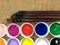 Collage of variety of colorful acrylic paints and art brushes