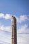 collapsed concrete chimney on the heat of a power plant and oil refinery after an air attack by missiles and drones