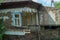 A collapsed floor in the room of a private house, fragment of the wall and window. Destruction of the foundation by groundwater.