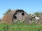 Collapsed wooden farm barn isolated