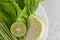 Collard green, lime, yard-long beans, and salad on a white plate