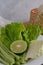 Collard green, lime, yard-long beans, and salad on a white plate