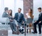 Colleagues applaud business partners at a business meeting