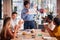 Colleagues Applauding As Businessman Gives Presentation In Modern Open Plan Office