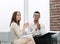 Colleagues applauding businessman sitting in office lobby