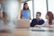 Colleagues discussing at desk during business metting