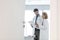 Colleagues discussing over medical records at desk seen through open door in hospital