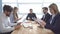 Colleagues look through documents. a business meeting. Group of young businessman at the negotiating table in the office