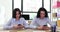 Colleagues managers seated with mobile phones in hands at table in office closeup
