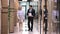 Colleagues walking in office hallway having business conversation