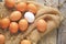 Collected chicken eggs, stacked on burlap in the chicken coop