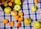 Collected pears, apricots and apples in basket on blue and white tissue in the kitchen. Summer and health.