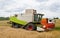 Collecting wheat combine, unloading seeds in truck