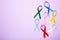 Collection of awareness ribbons on purple with copy space. World cancer day