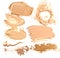 Collection of beige foundation and powder crushed cosmetic products on a white background.