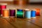 Collection of Brightly Colored Thread on Antique Wooden Spools on Wooden Planks