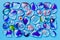 Collection of colorful glass beads of different sizes and shapes. Colored Venetian, Murano glass, millefiori. On a blue background