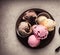 a collection of colorful ice cream on a chocolate plate