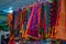 Collection of colorful sarees hanging in hangers in Indian shop