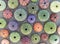 A collection of colorful sea urchin shells on wet sand beach, top view.