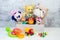 Collection of colorful toys on gray concrete background. Kids toys
