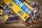 Collection of construction tools on wooden board top view