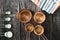 Collection of copper measuring cups and metal measuring spoons on old wood table