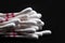 Collection of cotton buds to clean earwax isolated on black background
