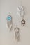 Collection of different tribal ethnic amulets hanging on beige wall boho scandi design dream catcher