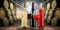 Collection of equisite red white and rose wine bottle glasseson wooden table in front of old rustic winery cellar background