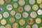 Collection of European coins on green cloth, top view