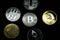 A collection of gold and silver cryptocurrency coins