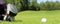 Collection of golf equipment resting on green grass