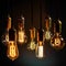 Collection of illuminated vintage Edison light bulb closeups in a dark setting