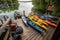 a collection of kayaks, canoes, and sups on a dock