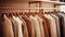 a collection of light brown sweaters neatly arranged on hangers in a well-lit and stylish boutique setting. the classic