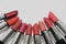 A collection of Mary Kay lipsticks in different shades lying open on a white background close up