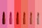 collection of matte lipstick tube on background, red, raspberry, pink, coral, peach color close-up, concept of decorative