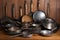 collection of metal cooking utensils, including woks and skillets