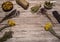 Collection, a mixture of various dried herbs in bundles and cups on a wooden background.