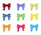 Collection of multi-colored bows on a white background.