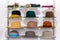 Collection of multicolored women`s hats on a rack in showcase of fashion boutique