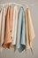 Collection of natural muslin kitchen towels are hung in a row on an unusual wooden hanger. Natural, soft, airy and
