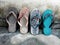 Collection of old slipper on dirty stone background. Close up. Colorful of slipper.