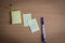 Collection of pins and note paper bunch and loose papers on wooden board. ball point pen. top view ready to fill your text and des